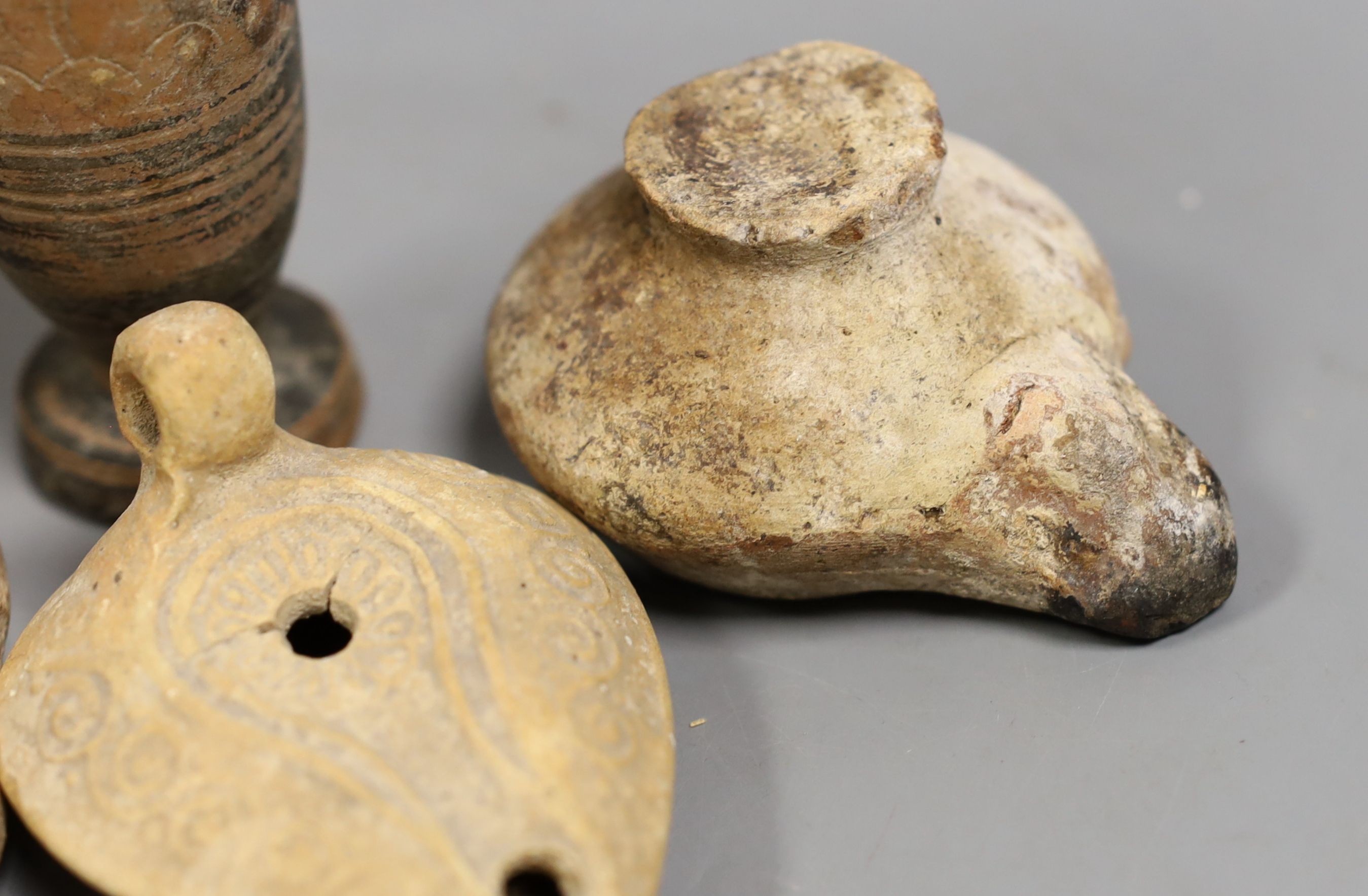 Two Ancient Greek painted pottery vessels, Apulia 3rd-4th century BC, two Roman/Byzantine oil lamps and a pilgrim flask, Tallest 15 cms high (5)